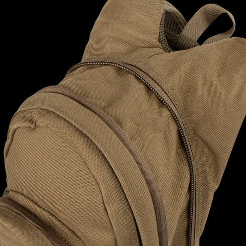 A close-up of the Condor Hydration Backpack 8L in tan canvas, featuring two zippered compartments—one partially unzipped—highlighting the top and front sections.